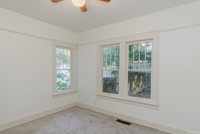 empty room with light carpet and ceiling fan