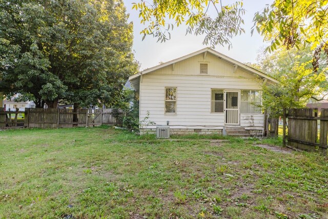 rear view of property with a lawn