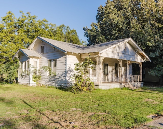 view of front of home featuring a front yard and a porch