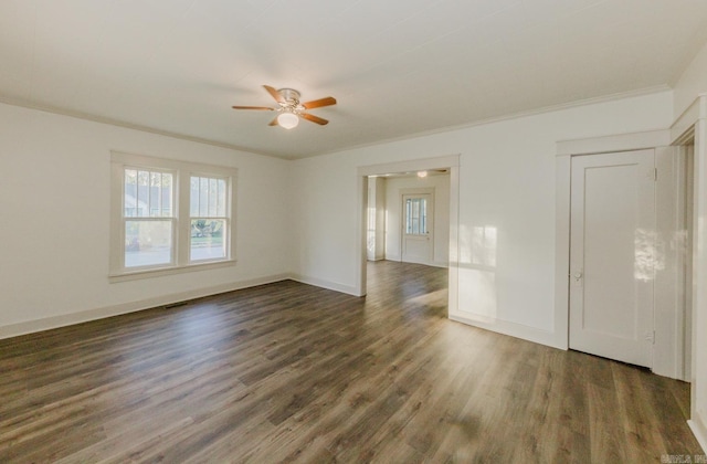 empty room with ceiling fan, dark hardwood / wood-style floors, and crown molding