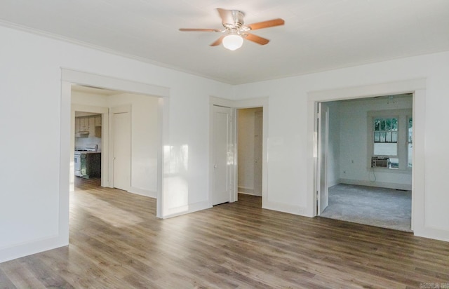 spare room featuring ornamental molding, ceiling fan, and hardwood / wood-style flooring