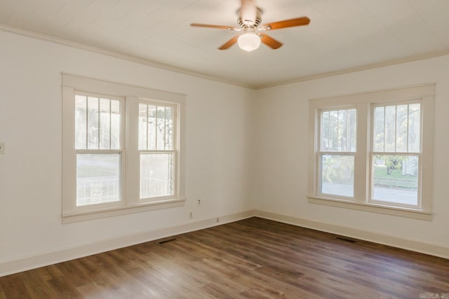 empty room with ceiling fan, dark hardwood / wood-style floors, and ornamental molding