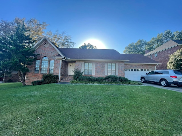 view of front of property with a front yard and a garage