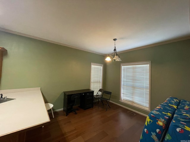 dining space with ornamental molding, a chandelier, and dark hardwood / wood-style floors