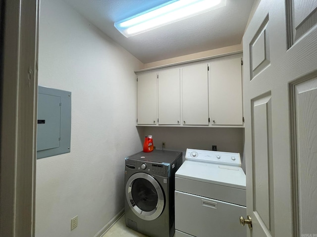 washroom with cabinets, electric panel, and washing machine and clothes dryer