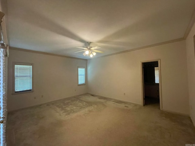 unfurnished room with light carpet, ornamental molding, and ceiling fan