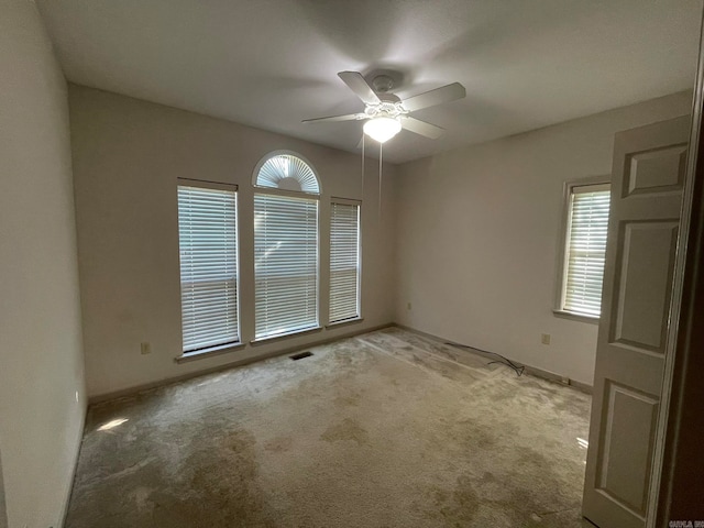 unfurnished room featuring ceiling fan and light colored carpet