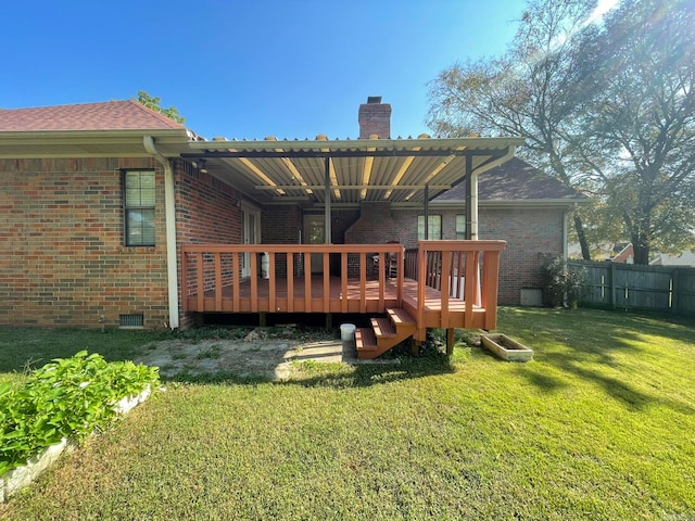 back of house featuring a lawn, a pergola, and a deck