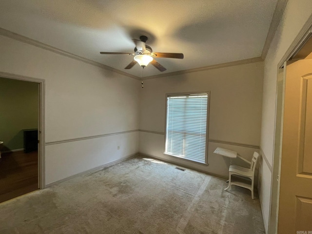 interior space with a textured ceiling, crown molding, and ceiling fan