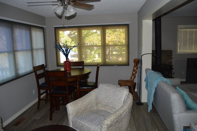 dining area with ceiling fan, a textured ceiling, and hardwood / wood-style floors