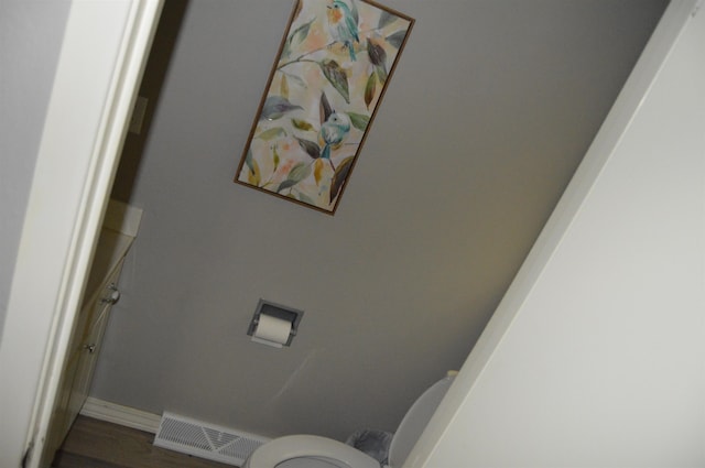 bathroom featuring hardwood / wood-style floors and toilet