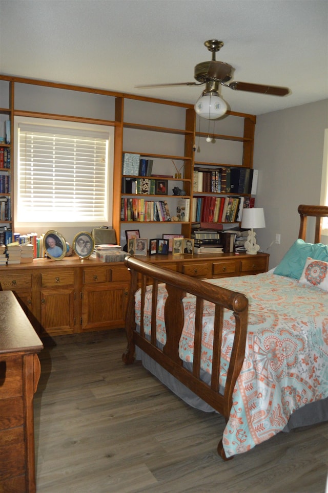 bedroom with ceiling fan and dark hardwood / wood-style flooring