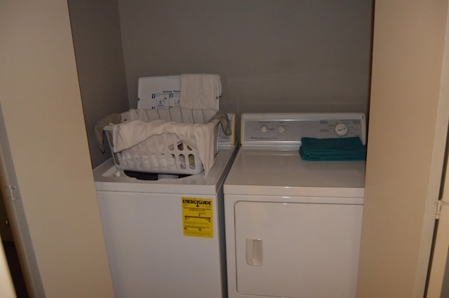 clothes washing area with separate washer and dryer