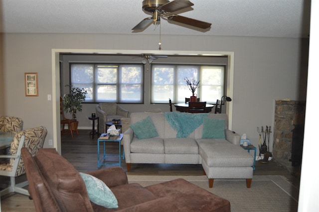 living room with wood-type flooring and ceiling fan