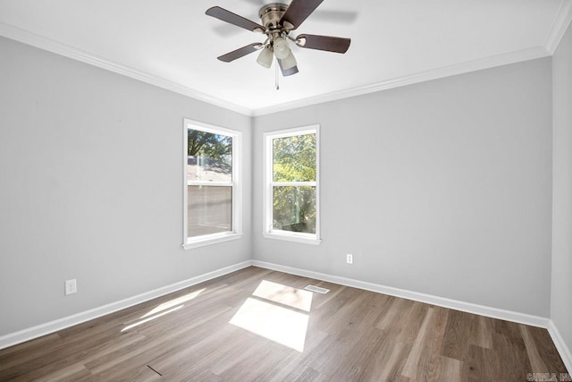 empty room featuring wood-type flooring, crown molding, and ceiling fan