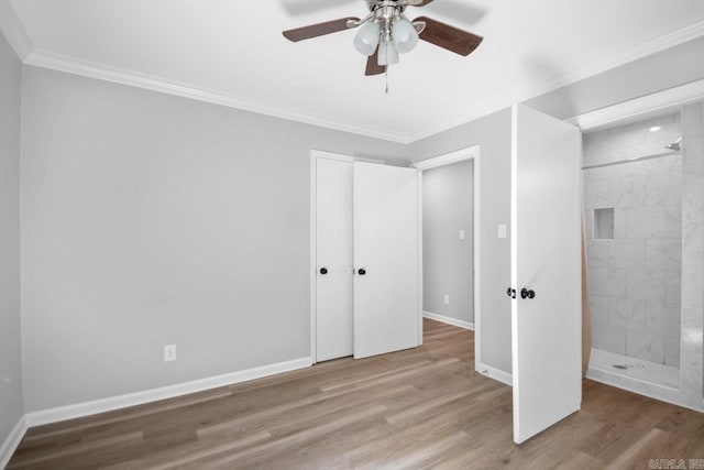 unfurnished bedroom featuring ornamental molding, a closet, light hardwood / wood-style floors, and ceiling fan