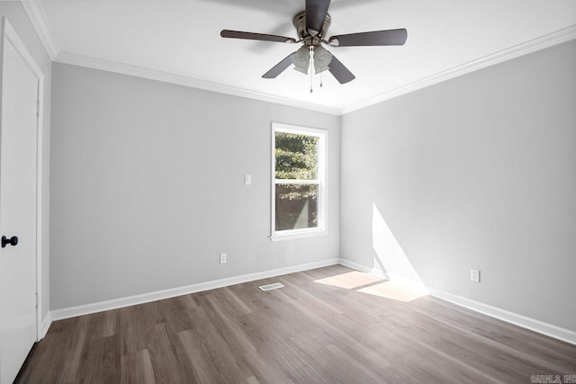 empty room featuring ornamental molding, wood-type flooring, and ceiling fan