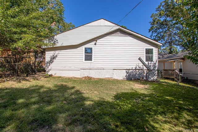 view of side of home with a yard