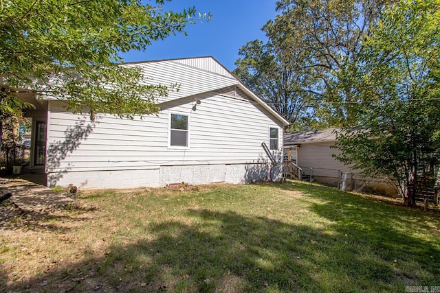 view of side of home featuring a yard