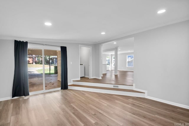 unfurnished living room with light hardwood / wood-style flooring and ornamental molding