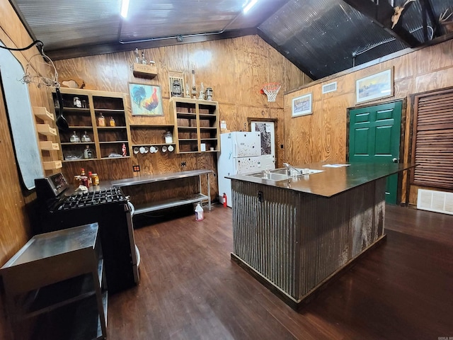 interior space with gas stove, built in features, dark hardwood / wood-style floors, wood walls, and lofted ceiling