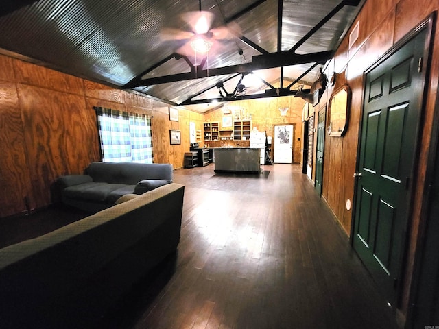 living room with wood walls, lofted ceiling with beams, ceiling fan, and dark hardwood / wood-style flooring