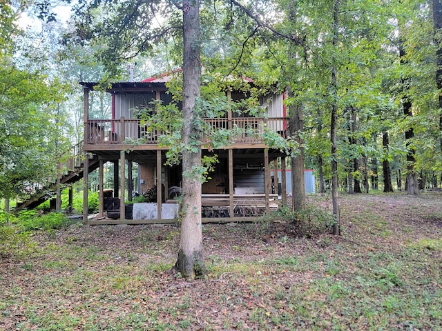 rear view of house featuring a wooden deck