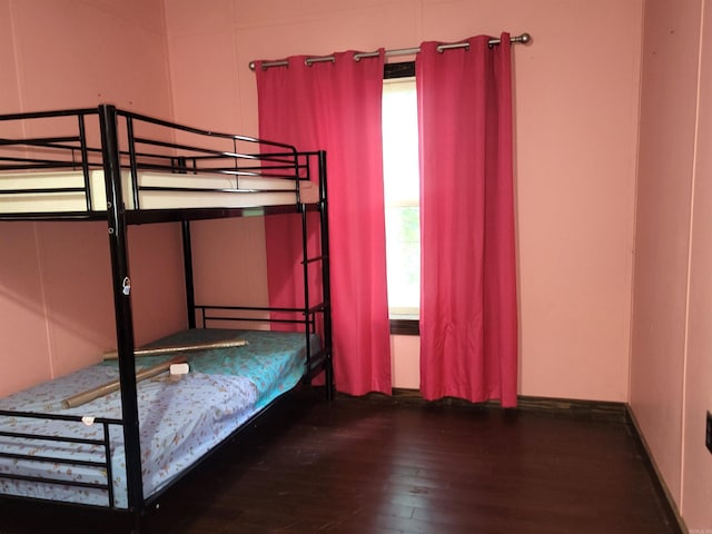 unfurnished bedroom with dark wood-type flooring