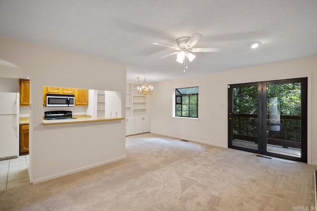 unfurnished living room with light colored carpet, a textured ceiling, and ceiling fan with notable chandelier