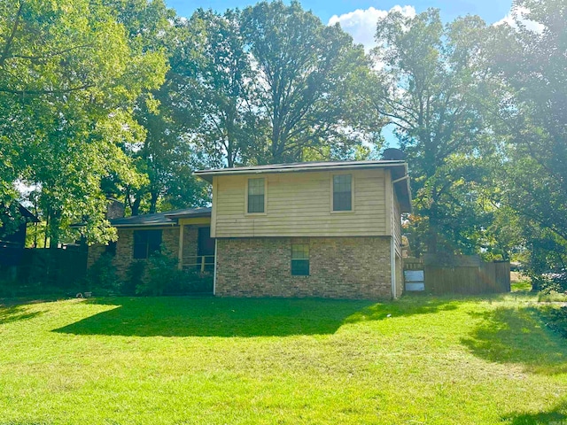 rear view of house with a yard