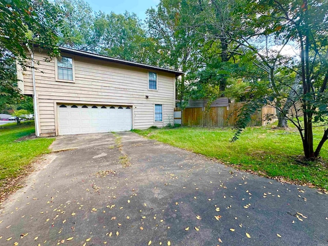 view of side of home with a garage and a yard