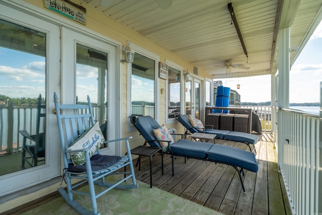 wooden terrace featuring a water view and ceiling fan