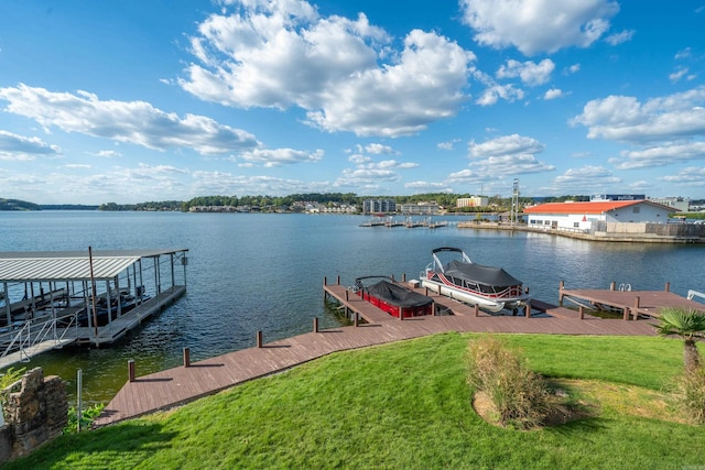 view of dock with a water view and a yard