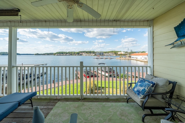 balcony with ceiling fan and a water view