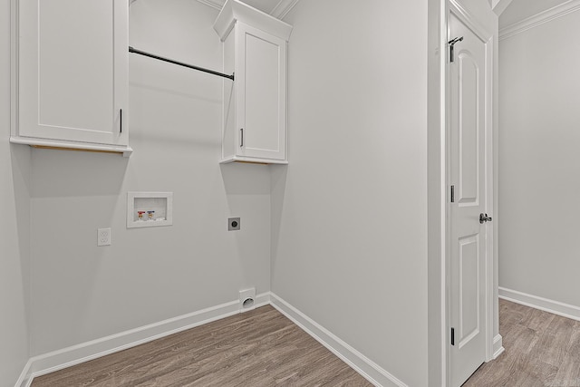 clothes washing area with washer hookup, ornamental molding, light hardwood / wood-style flooring, cabinets, and electric dryer hookup