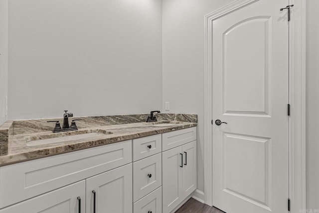 bathroom with hardwood / wood-style flooring and vanity