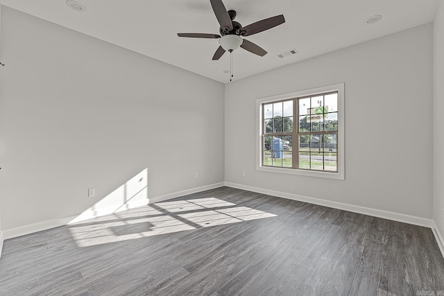 empty room with ceiling fan and dark wood-type flooring