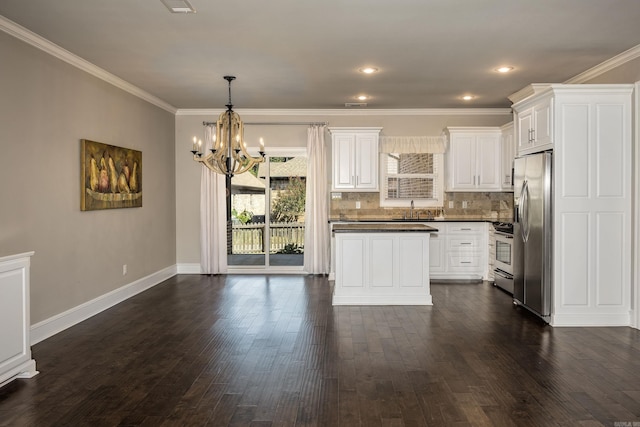 kitchen featuring white cabinetry, dark hardwood / wood-style flooring, stainless steel appliances, ornamental molding, and sink