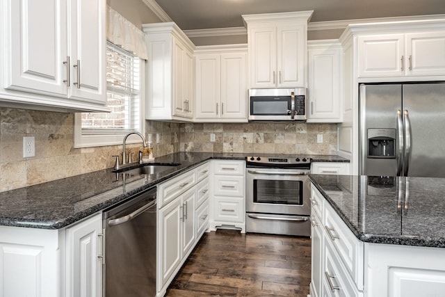 kitchen with white cabinets, ornamental molding, sink, appliances with stainless steel finishes, and dark hardwood / wood-style floors