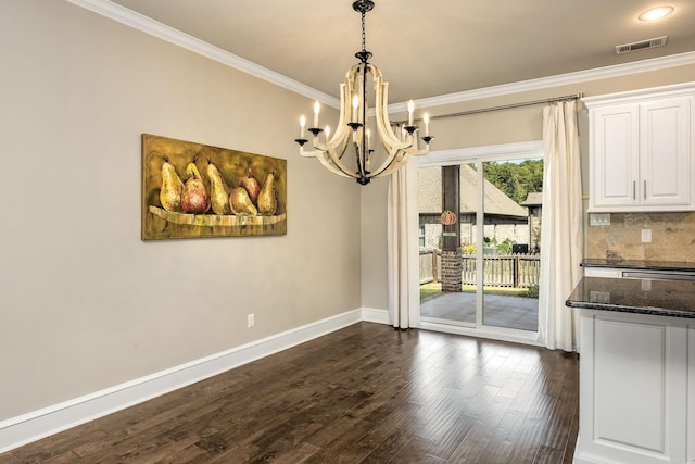 unfurnished dining area with ornamental molding, a notable chandelier, and dark wood-type flooring