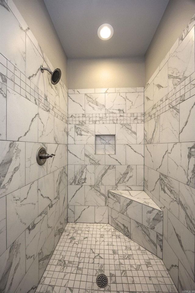 bathroom with a tile shower