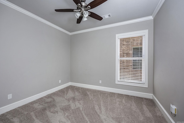 carpeted empty room with ceiling fan and ornamental molding