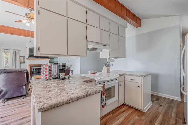 kitchen with light hardwood / wood-style floors, lofted ceiling, white cabinetry, white electric stove, and ceiling fan