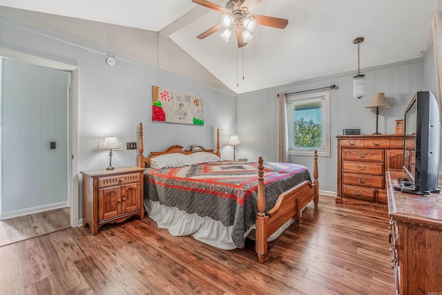 bedroom featuring ceiling fan, hardwood / wood-style flooring, and vaulted ceiling