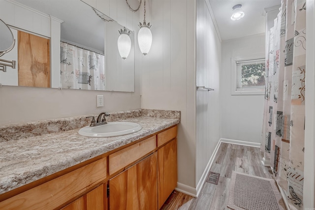 bathroom with vanity, a shower with curtain, hardwood / wood-style flooring, and crown molding