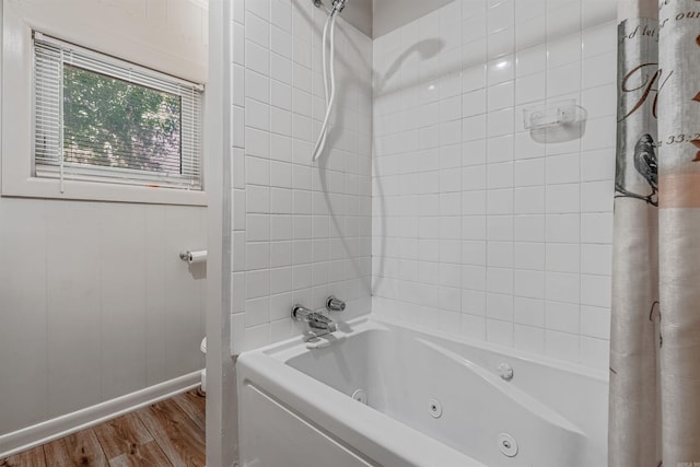 bathroom with shower / tub combo and hardwood / wood-style floors