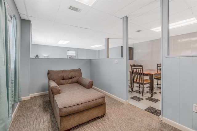 sitting room with carpet flooring and a paneled ceiling