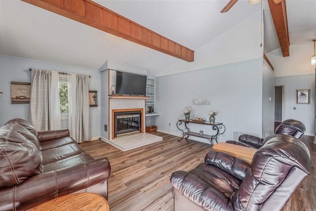 living room featuring a fireplace, lofted ceiling with beams, ceiling fan, and light hardwood / wood-style flooring