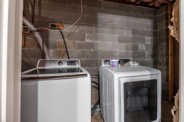 clothes washing area with washing machine and dryer