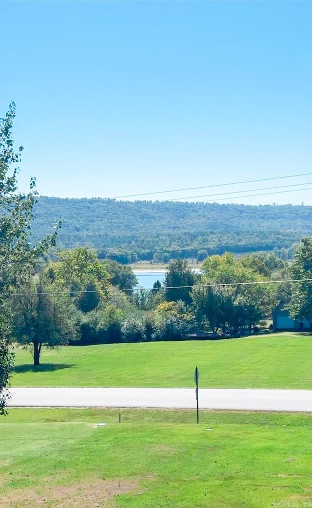 view of community with a yard and a water view